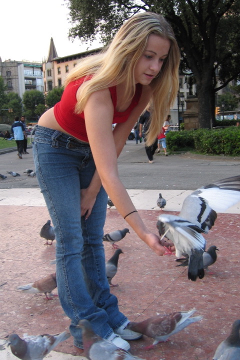 Jacey feeds a pigeon