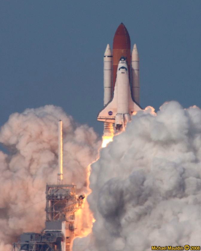 (T+4s) the shuttle rises from behind the steam