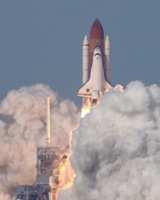 (T+4s) the shuttle rises from behind the steam